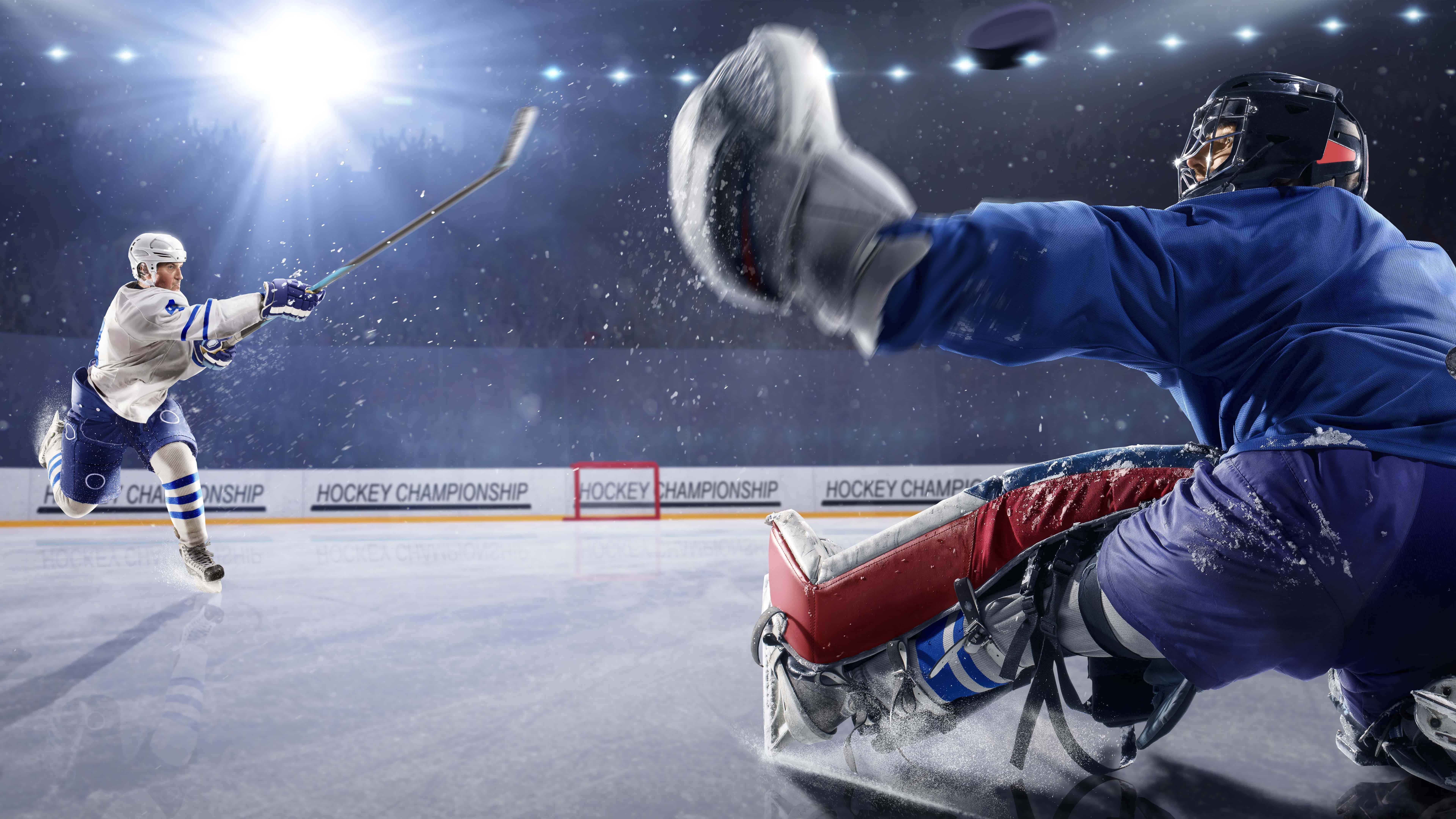 hockey-player-shooting-puck-at-goalie-uhd-8k-wallpaper-pixelz